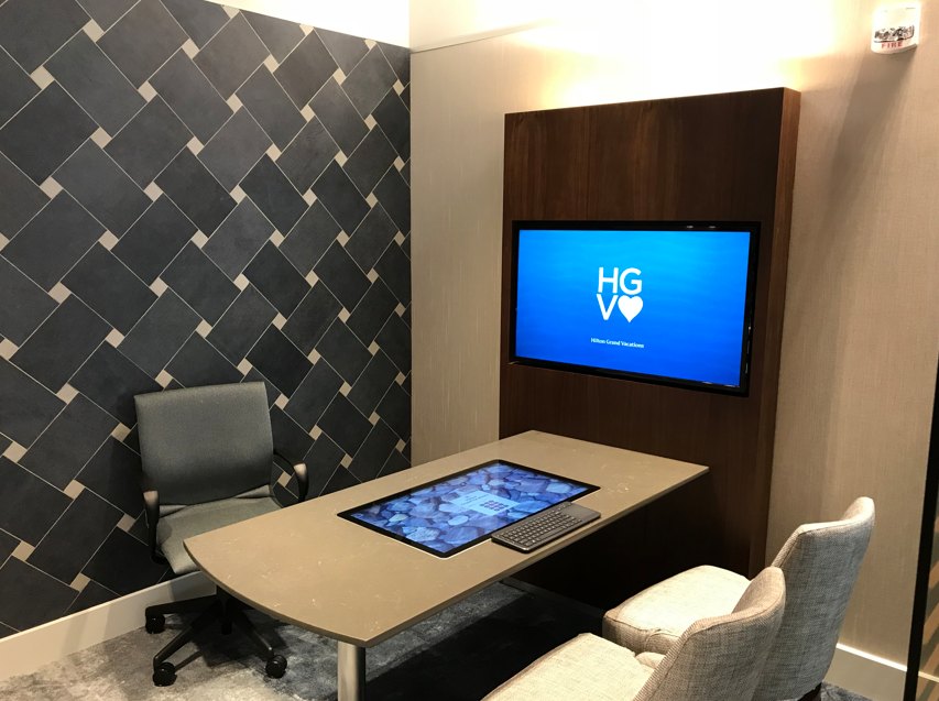 Private sales room with touch table and wall display