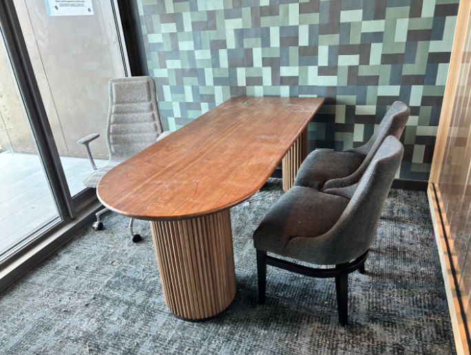 Sales table beside a tiled feature wall
