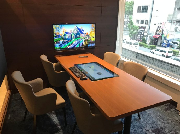 Conference-style sales table with touch display