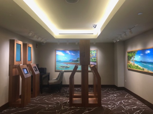 Sales gallery entry with check-in kiosks and wall displays